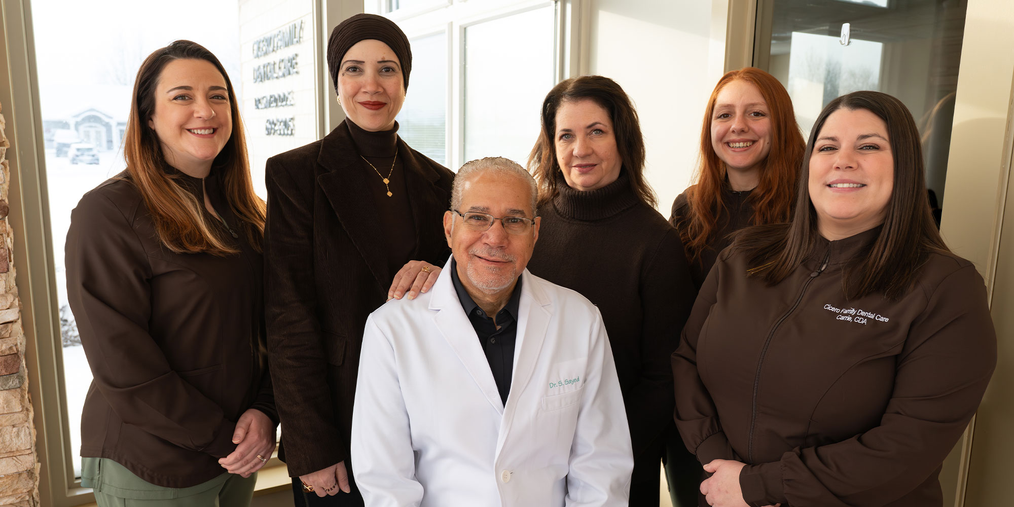 Doctor and his team smiling together