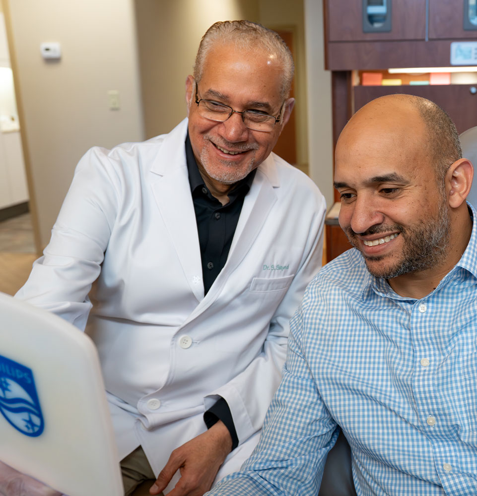 Patient and doctor looking into mirror
