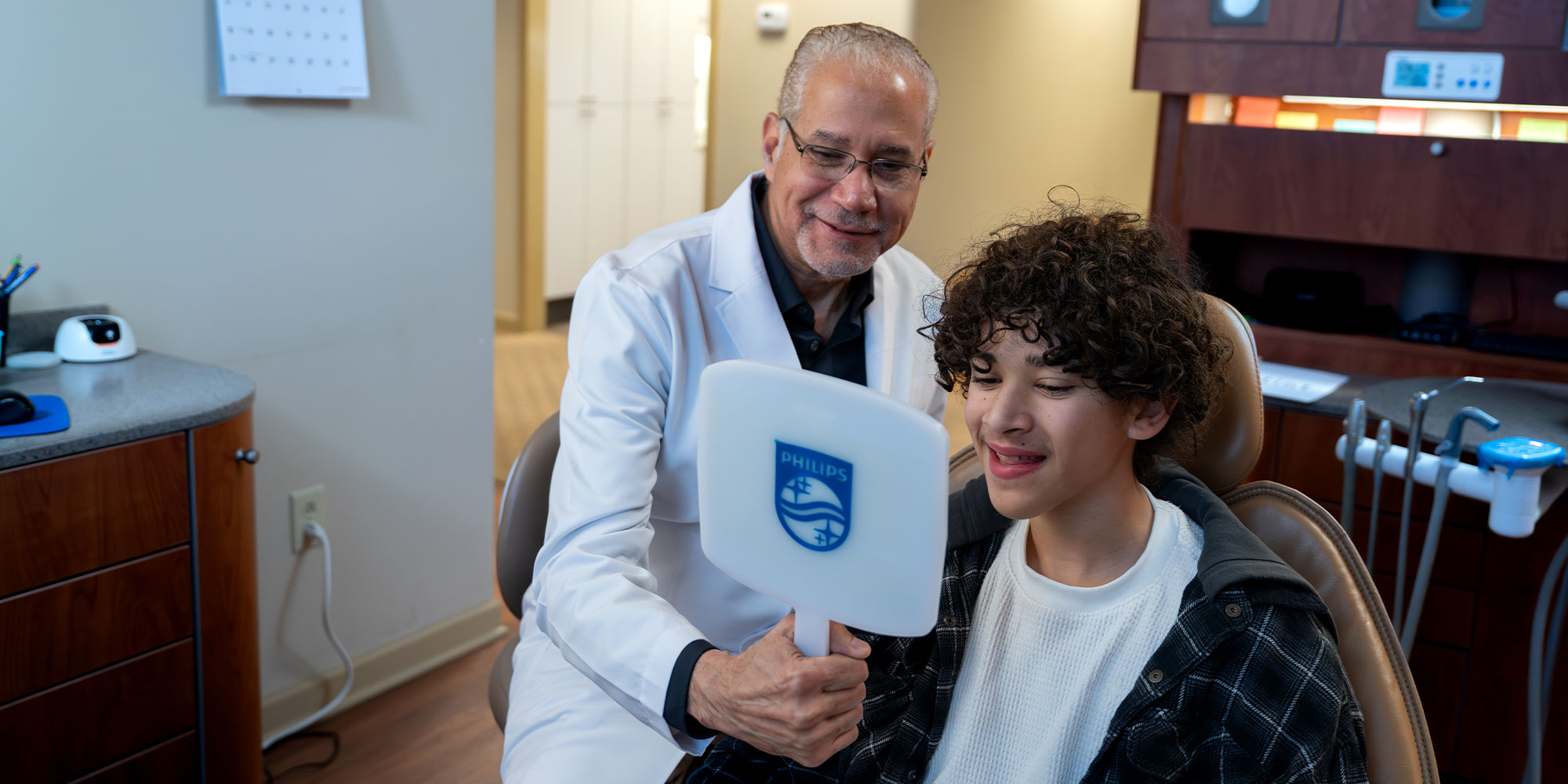 Patient and team member looking into mirror